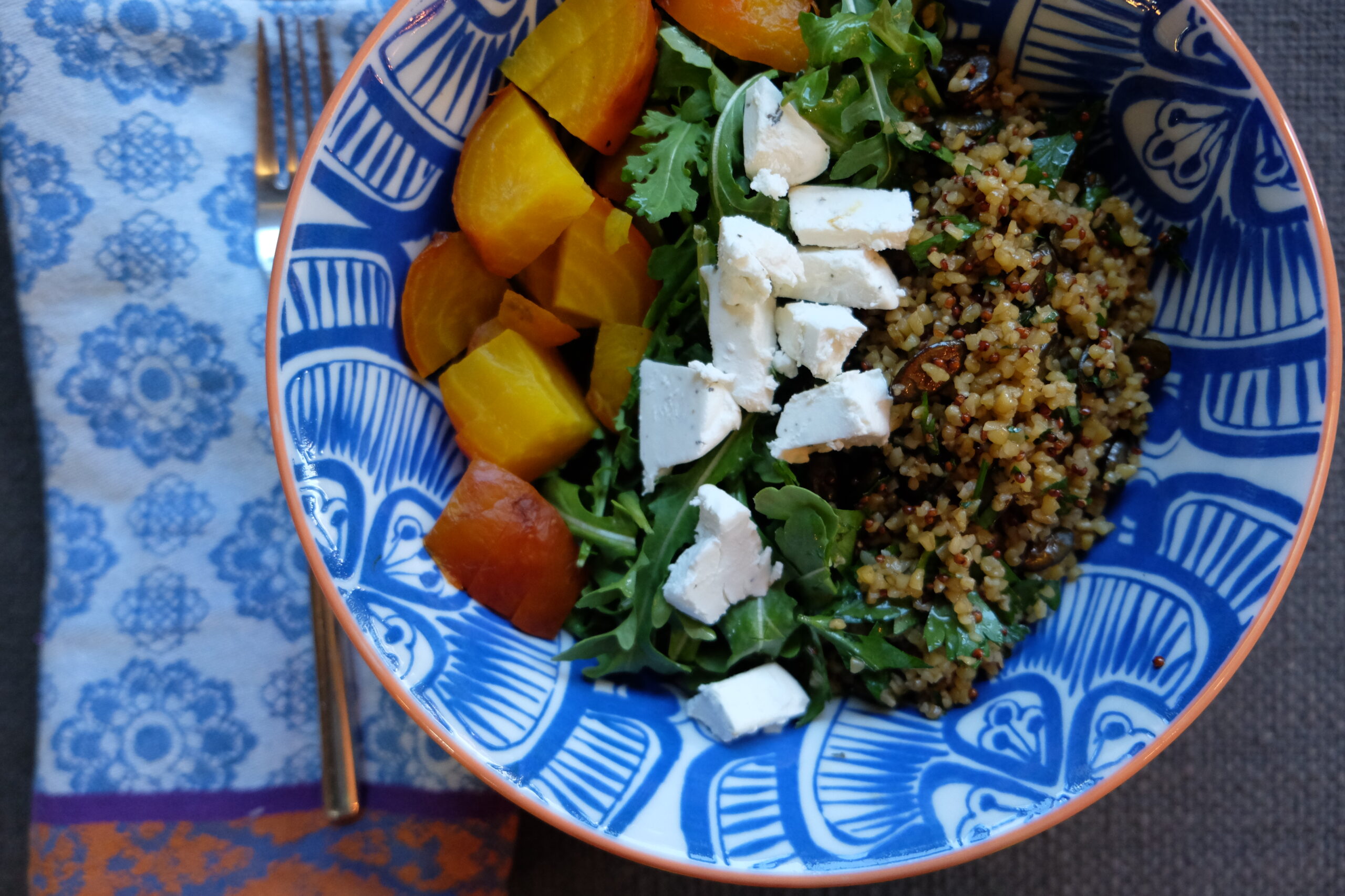 composed salad of golden beets, arugula and grains w/ lemony herb dressing